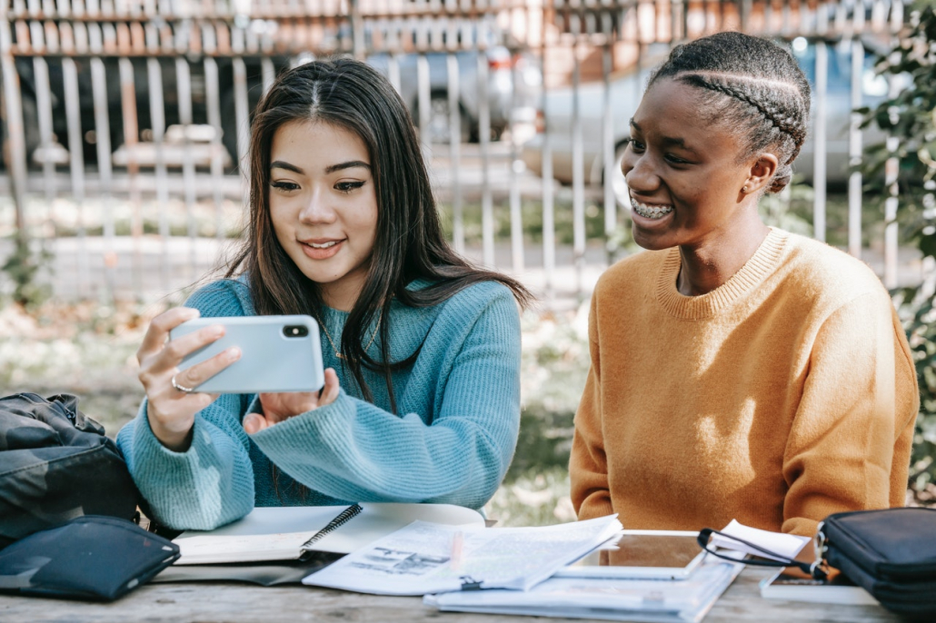 Two women communicating with telephone translation services